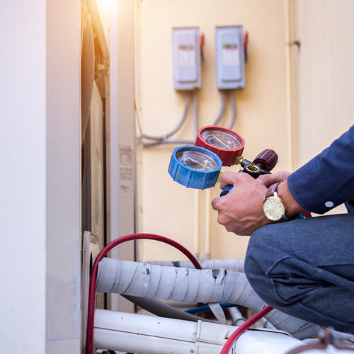 A Technician Checks an AC.